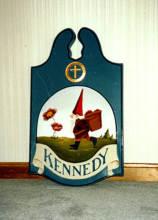 Hand-carved Kennedy sign with gnome carrying flowers